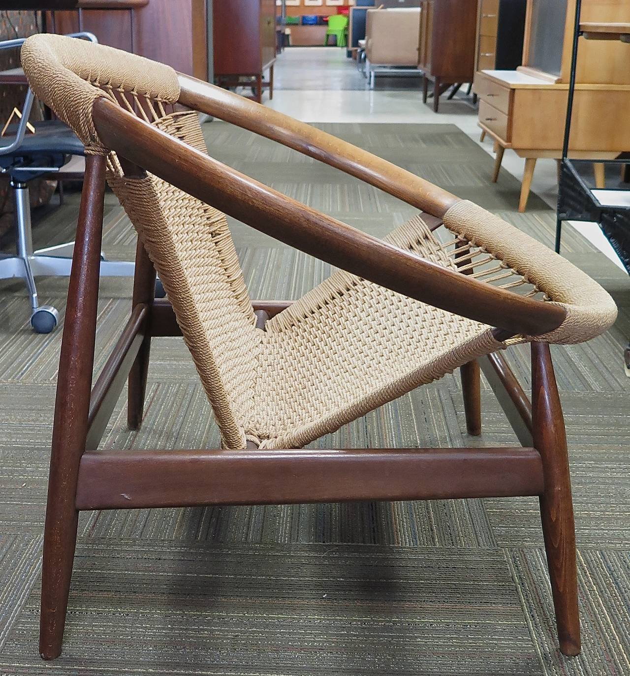 Teak wood construction. Jute seat. Cord is dry, but no breaks. Wood has normal wear from use. Arm rest area is slightly lighter than the rest of the chair with some mild finish wear along the legs. Overall this is a great comfortable chair with