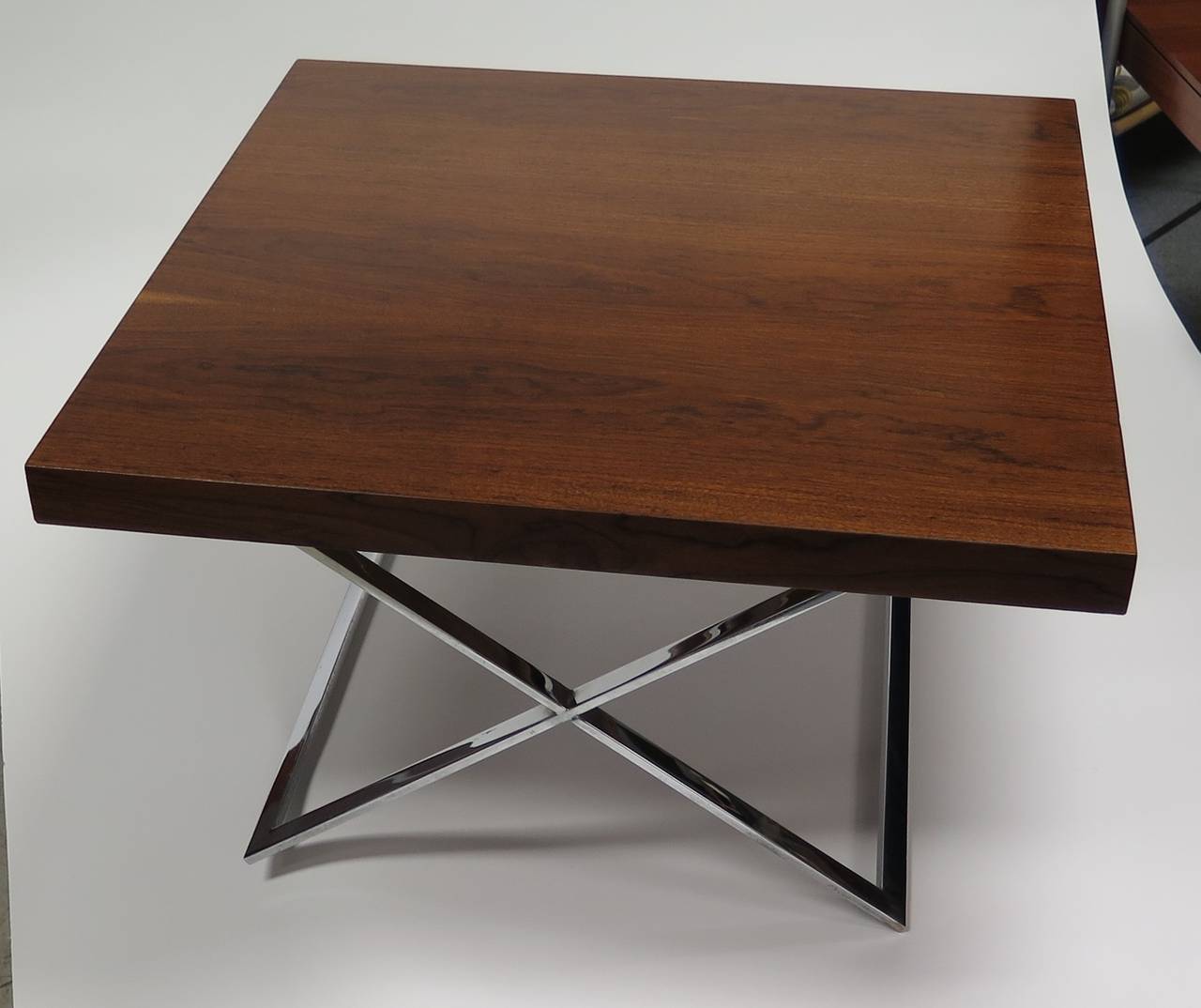Restored walnut top. Solid chrome base. Small grey area on chrome, otherwise in excellent condition. Versatile piece.