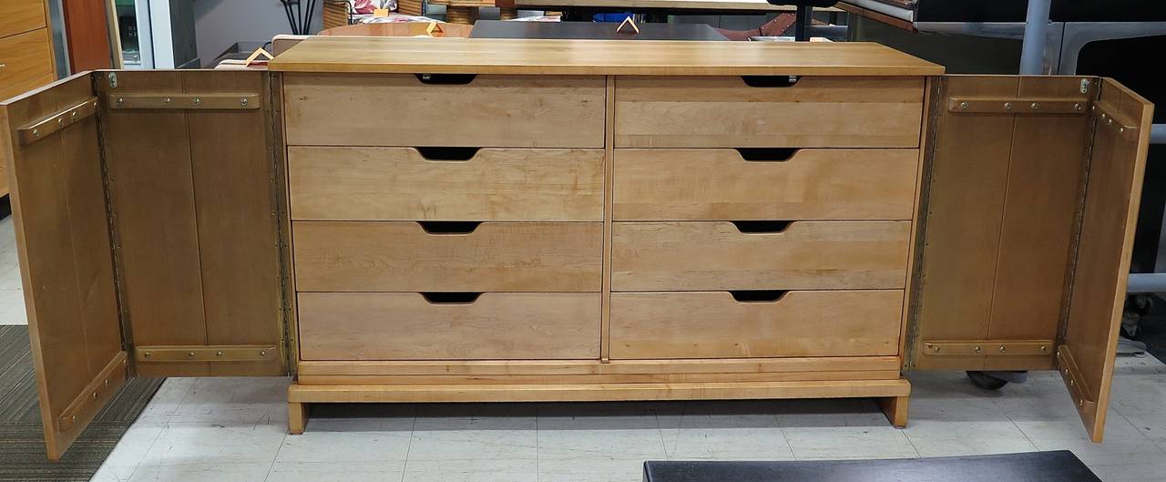 Restored. Solid maple. 8 drawers behind 2 doors. Few dark spots, minor wood separation. Really fantastic storage piece!