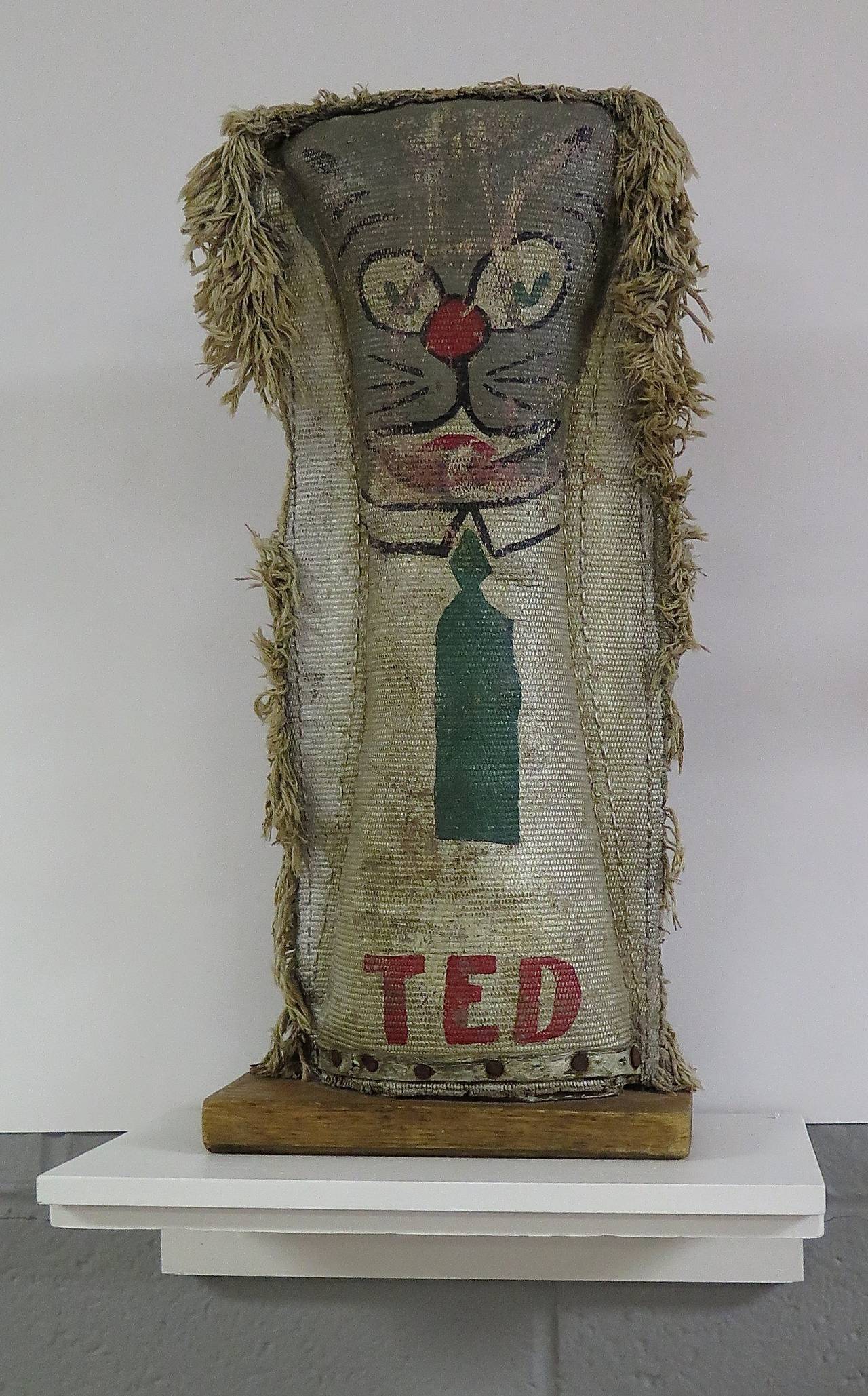 Circa 1930-40s carnival knock-downs. Group of cats. Straw-filled, one with wood inside. Canvas and wool fluff. All mounted on wooden bases. Various sizes, measurement given is for the largest of the group.