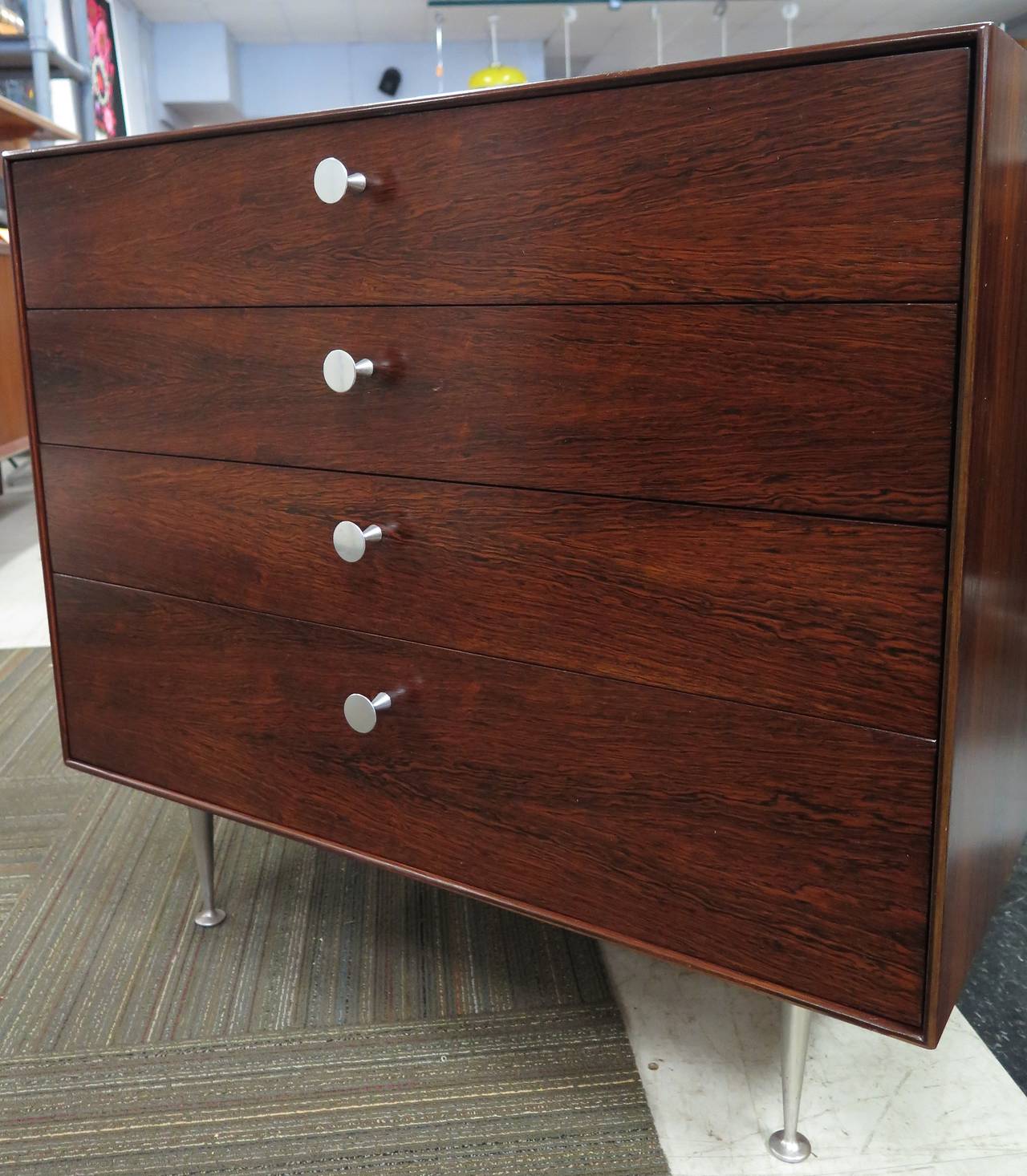 Label. Restored. Rosewood construction with aluminum pulls and legs. Excellent condition. Top drawer has removable dividers.