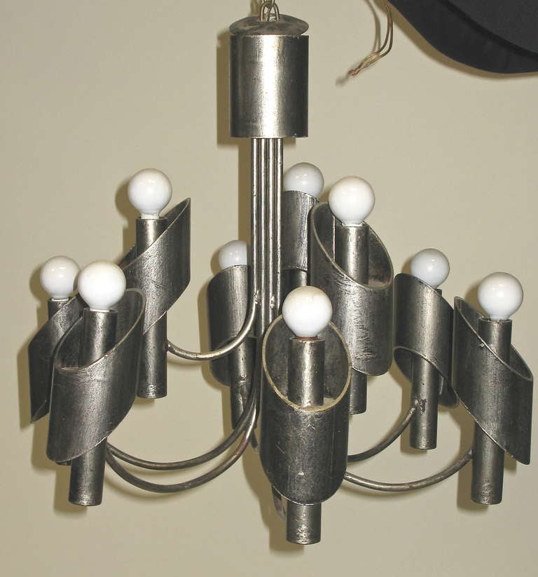 Silver finish with black wash. 9 individual lights. Very heavy. Works great. Each individual light measures 8 inches high, 3.5 inches diameter.