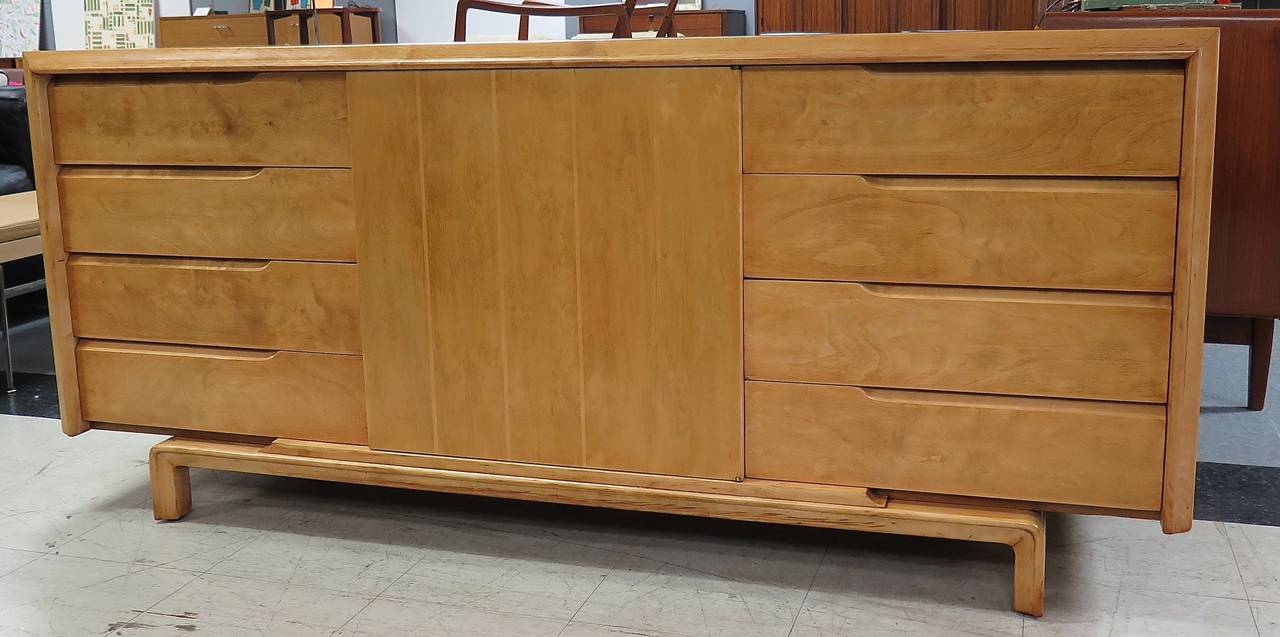 Made in Sweden. Restored, nice color. 8 drawers. 1 center door with 1 adjustable shelf behind and 1 pull out tray. Some minor staining on bottom edges.