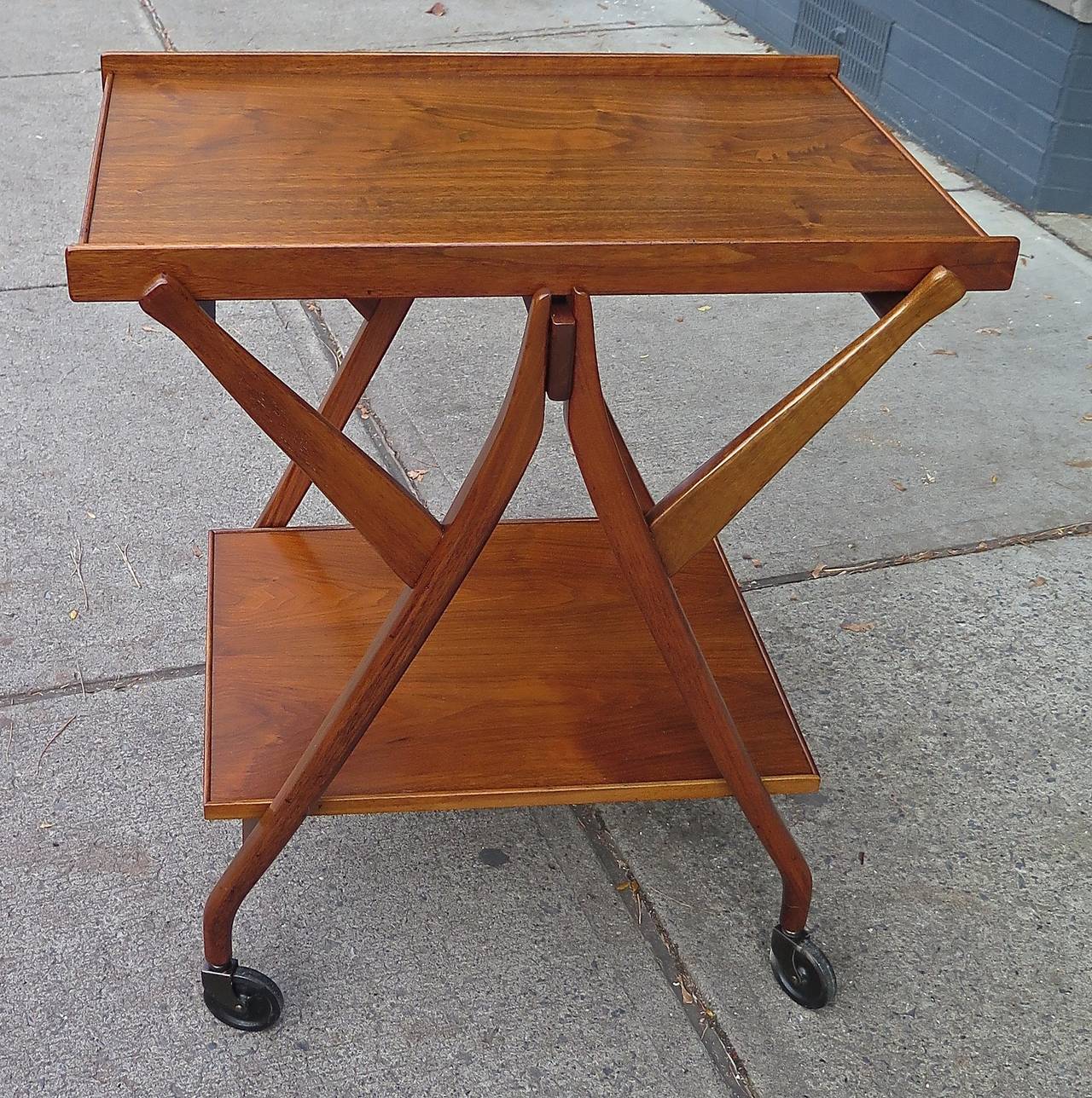 Declaration Series. Restored. Removable top tray. Walnut, reddish-brown color. Plastic wheels good condition. Some scuffing on tray under new lacquer.