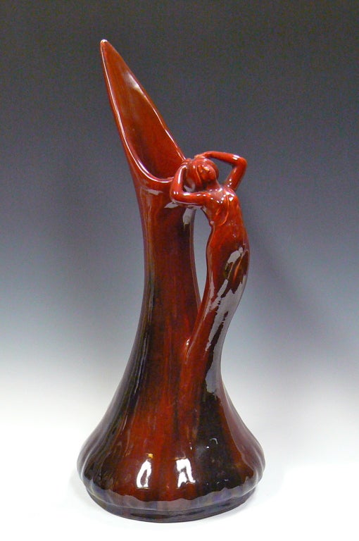 This art nouveau red ceramic pitcher made by Jerome Massier (1850-1926) features a handle modeled in the form of a girl. French art pottery typically featured such innovative ways to incorporate the female form. Original paper label 