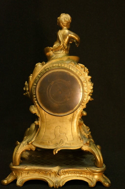Tiffany and Company produced some of the finest decorative bronze ware of this period. This Louis XV  dore' bronze clock exemplifies the refined manufacture and fanciful style that has become synonymous with Tiffany quality. The rococo style of the