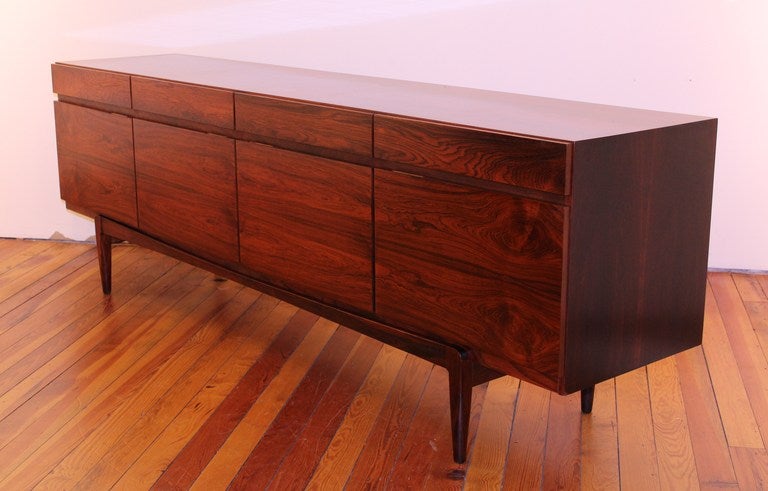 Excellent Rosewood credenza.  Beautiful grain with rich color. Functional 4 drawers across the top with smaller section of drawers and open shelf storage.