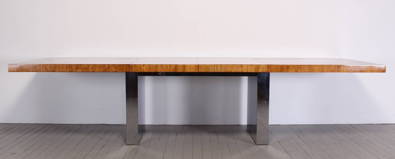 A great Milo Baughman patchwork dining table on a chrome base. Beautiful elm top veneers in a parquet style. Professionally restored by Alternative Furnishings Inc. The table has two large leaves which extends to 122.25 inches. 78