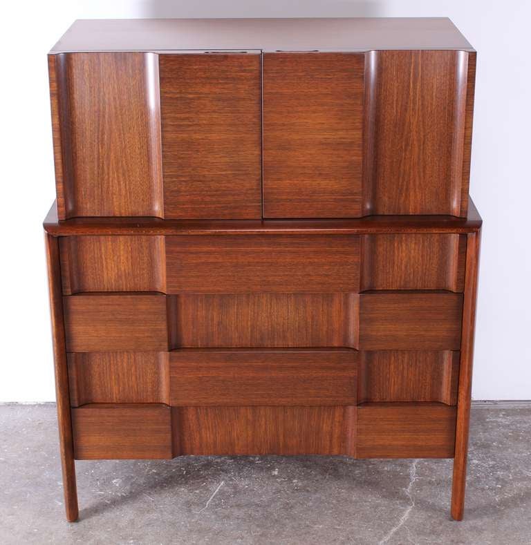 A spectacular relief front walnut tall chest made of horizontal and vertical walnut veneer designed by Edmund Spence Sweden. The intersecting lines of graining create an exquisite rich contrast.