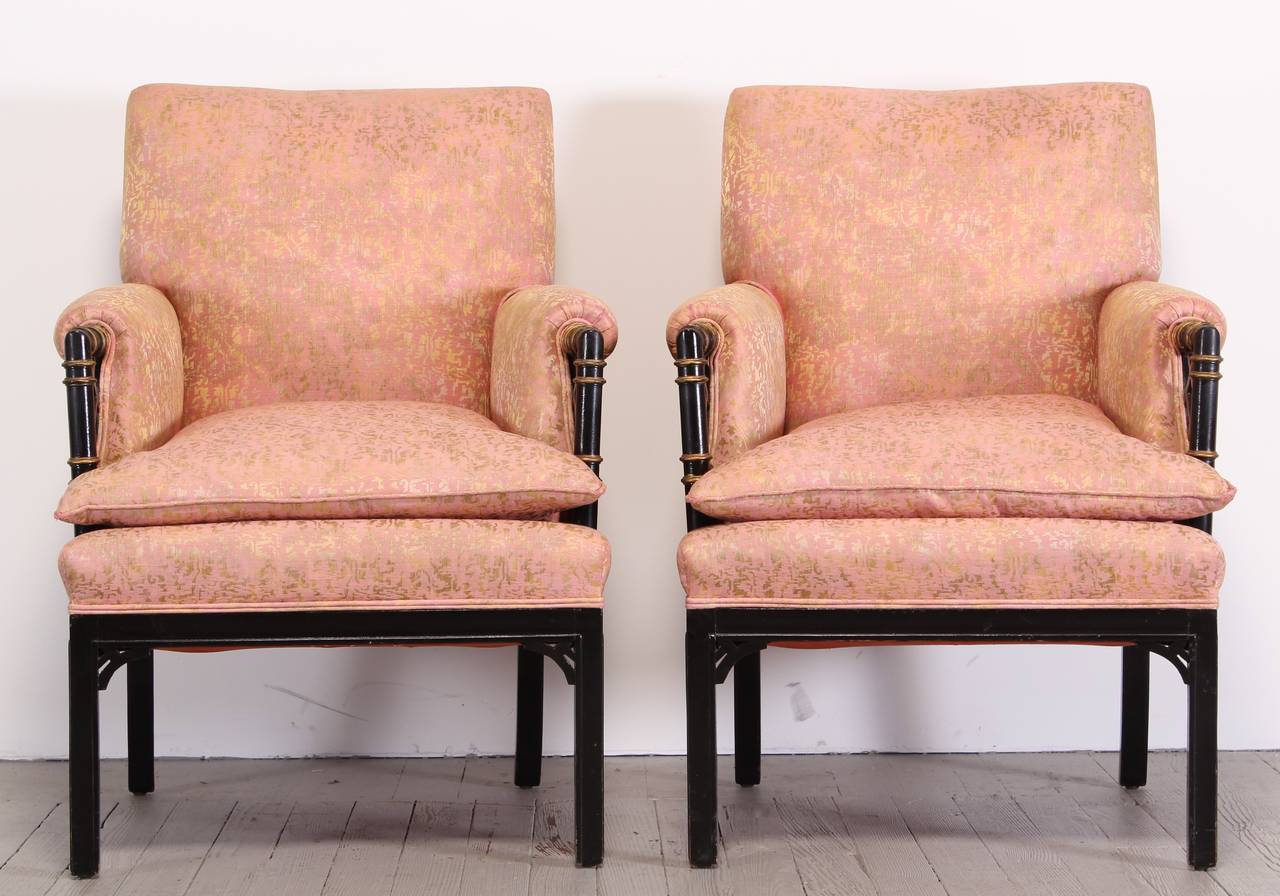 A great pair of classic Ebonized Faux Bamboo Hollywood Regency Arm Chairs. Original fabric clean, some minor wear. Refinishing and upholstery services available at Alternative Furnishings Inc. Please inquire for quotes. New York City Delivery would