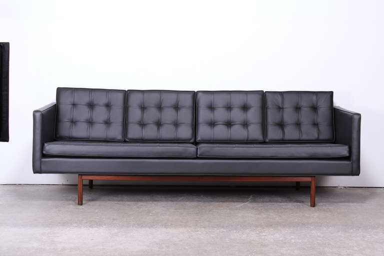 A fabulous and luxurious black leather sofa designed by Milo Baughman for Thayer Coggin.  Newly upholstered black leather, beautifully pleated double sided leather cushions. Wood is original walnut finish.