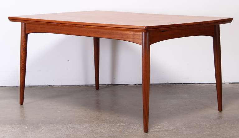 A beautiful Danish teak dining table with simple Mid-Century Modern design. Extends to 108