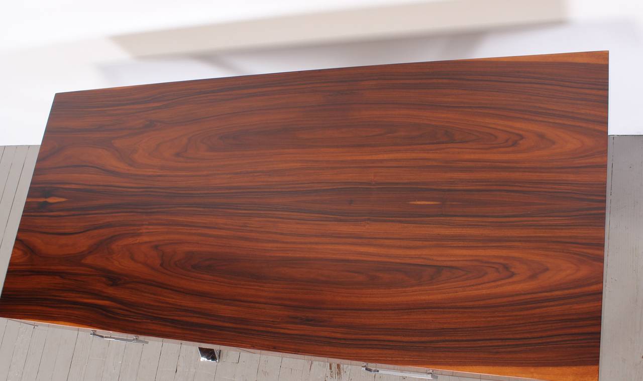An excellent rosewood and chrome desk by Milo Baughman. Refurbished in a highly durable Italian catalyzed polyurethane. It has been hand rubbed using seven different grades of abrasives to achieve the deep gloss. This professional finish is newly
