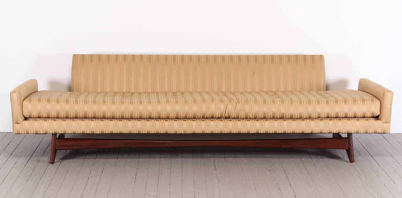 An Adrian Pearsall sofa for Crafts Associates, model 2408, with sculptural walnut leg supports. Extra long version of this sofa. New fabric suggested. Cushions not available.