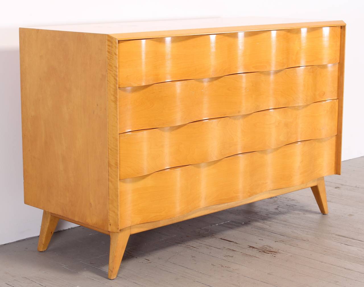 A beautiful wave front design chest by Edmond Spence, Sweden, 1950. New York City Delivery would be $249.00.