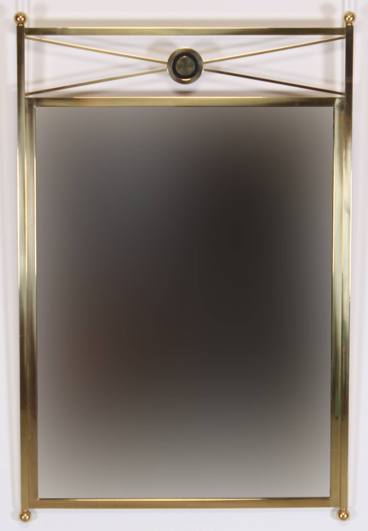 A Classic neoclassical brass mirror with black enamel accent mirror by Baker, 1970. Mirror professionally packed via UPS Store or Maildock. Please inquire for an individual quote.