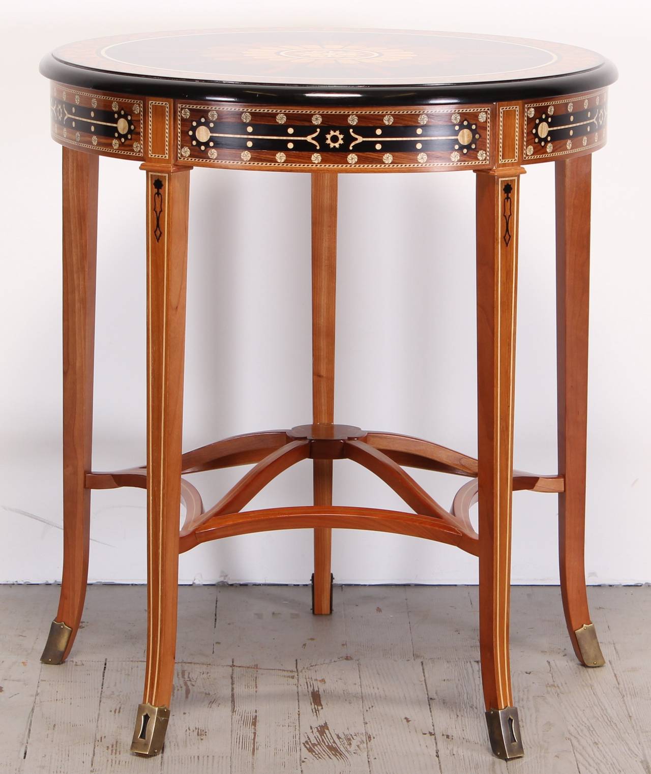 The top of this elegant occasional table is inspired by 5th century Indian printed textiles. The radiant inlay pattern is a study in exotic native Indian woods. Satinwood, Indian rosewood and Macassar ebony are combined
to form a lotus petal