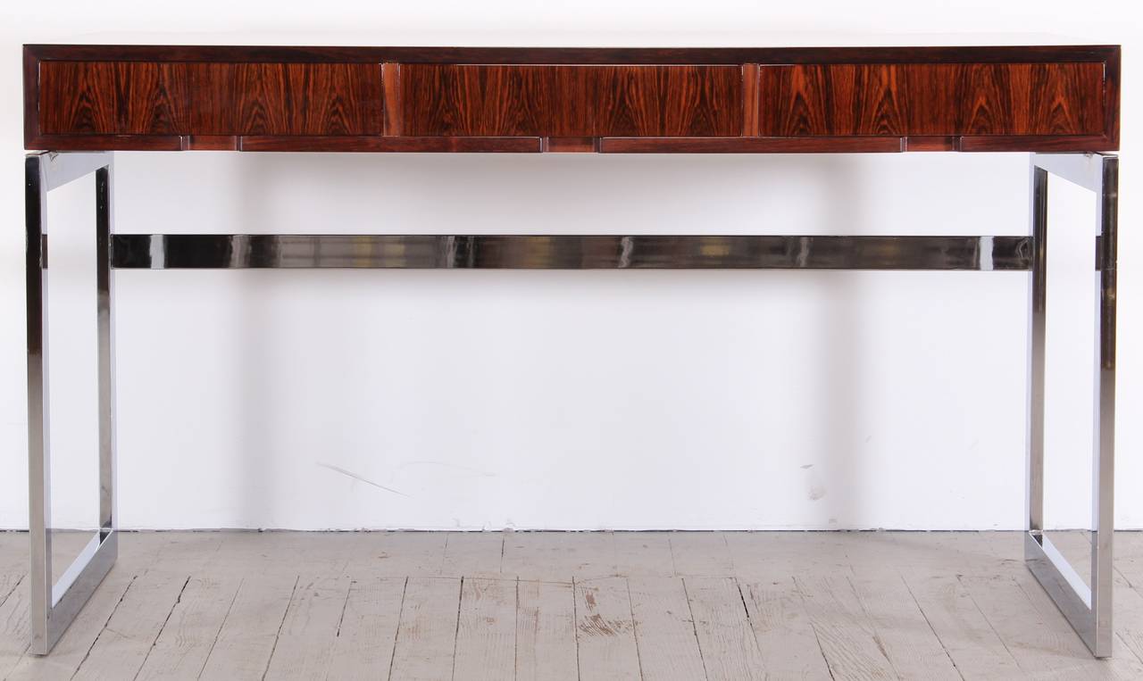 A chic rosewood and chrome base desk by Milo Baughman, 1970. Professionally refinished by Alternative Furnishings Inc. New York City Delivery would be $249.00.