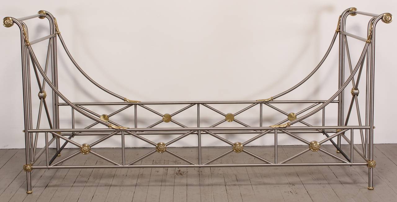 A Maison Jansen Italian style daybed made of brushed steel and brass with neoclassical cross based ends and brass rosettes with acanthus leaf accents. New York City Delivery would be $249.00.