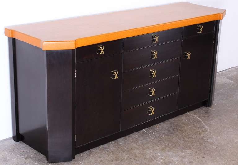 Credenza / Sideboard has a beautifully restored ebonized glazed finish with original cork top and polished brass pulls.
