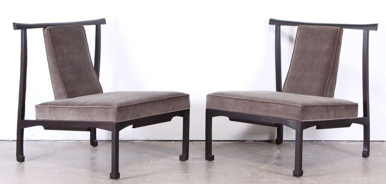 A great pair of James Mont style lounge chairs finely refinished in matte ebony stain.  Newly upholstered in mink grey velvet.