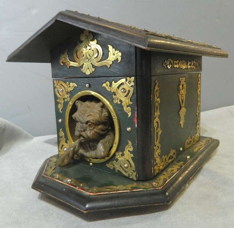 Humidor dog house with brass overlay decoration on wood painted green.  It was made in the 1890's in Europe.