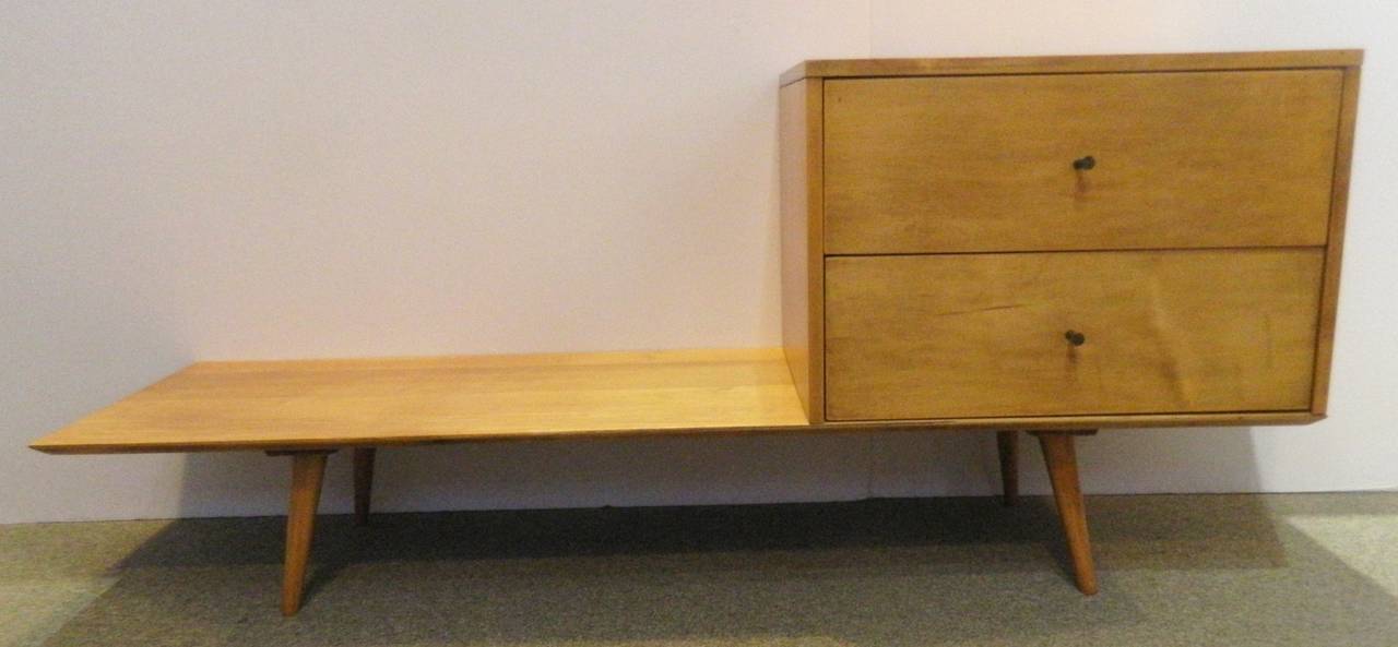 Mid-Century bench and cabinet designed by Paul McCobb Planner Group and produced by Winchendon in the 1950s. This is a single piece of furniture with combined seating and storage. Two drawers with metal bronze color pulls. The bench is constructed