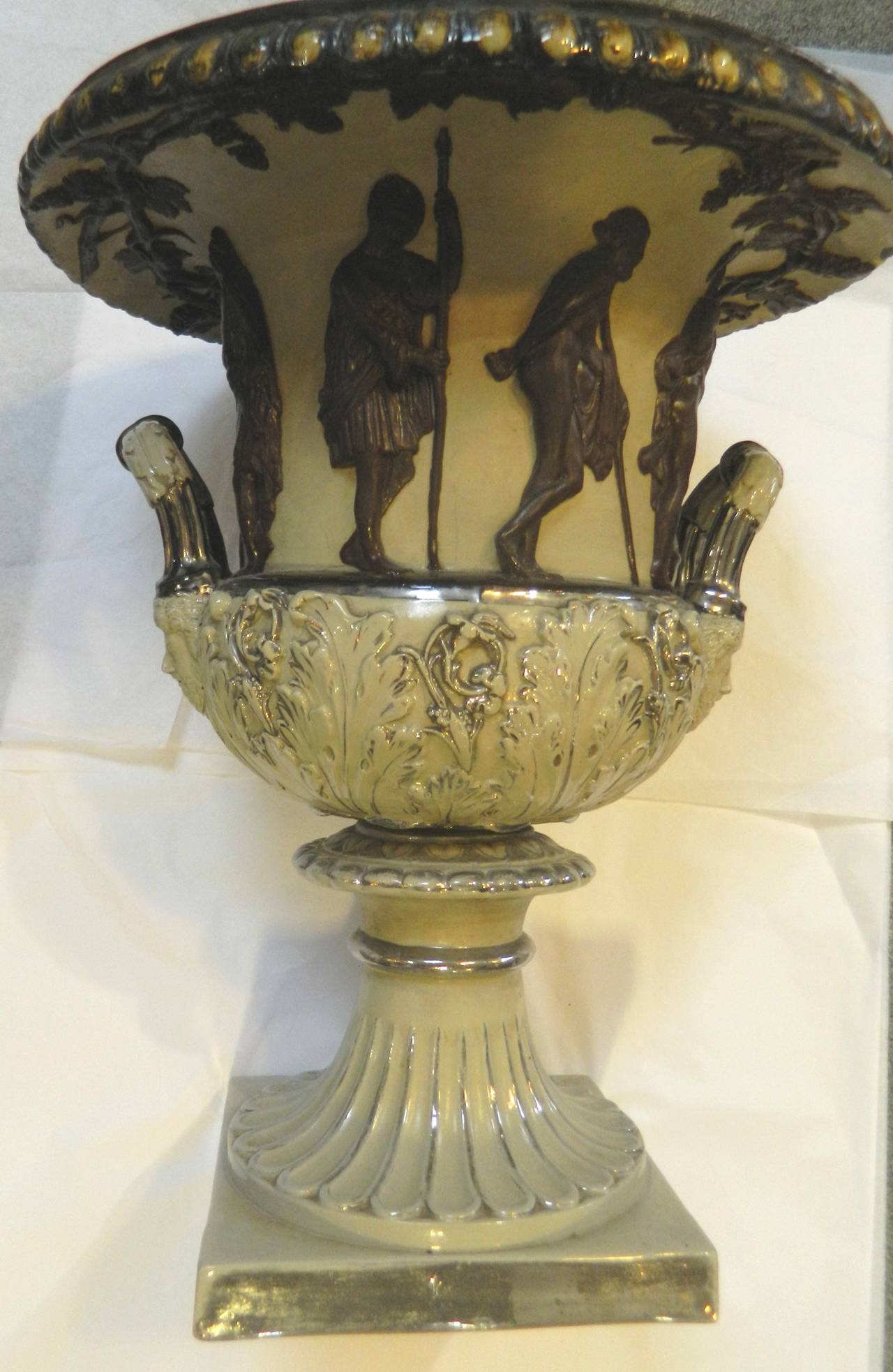 Greek Revival large stoneware urn with taupe ground, dark brown raised figures and silver highlights, circa 1850s. The figures are quite large- most 5