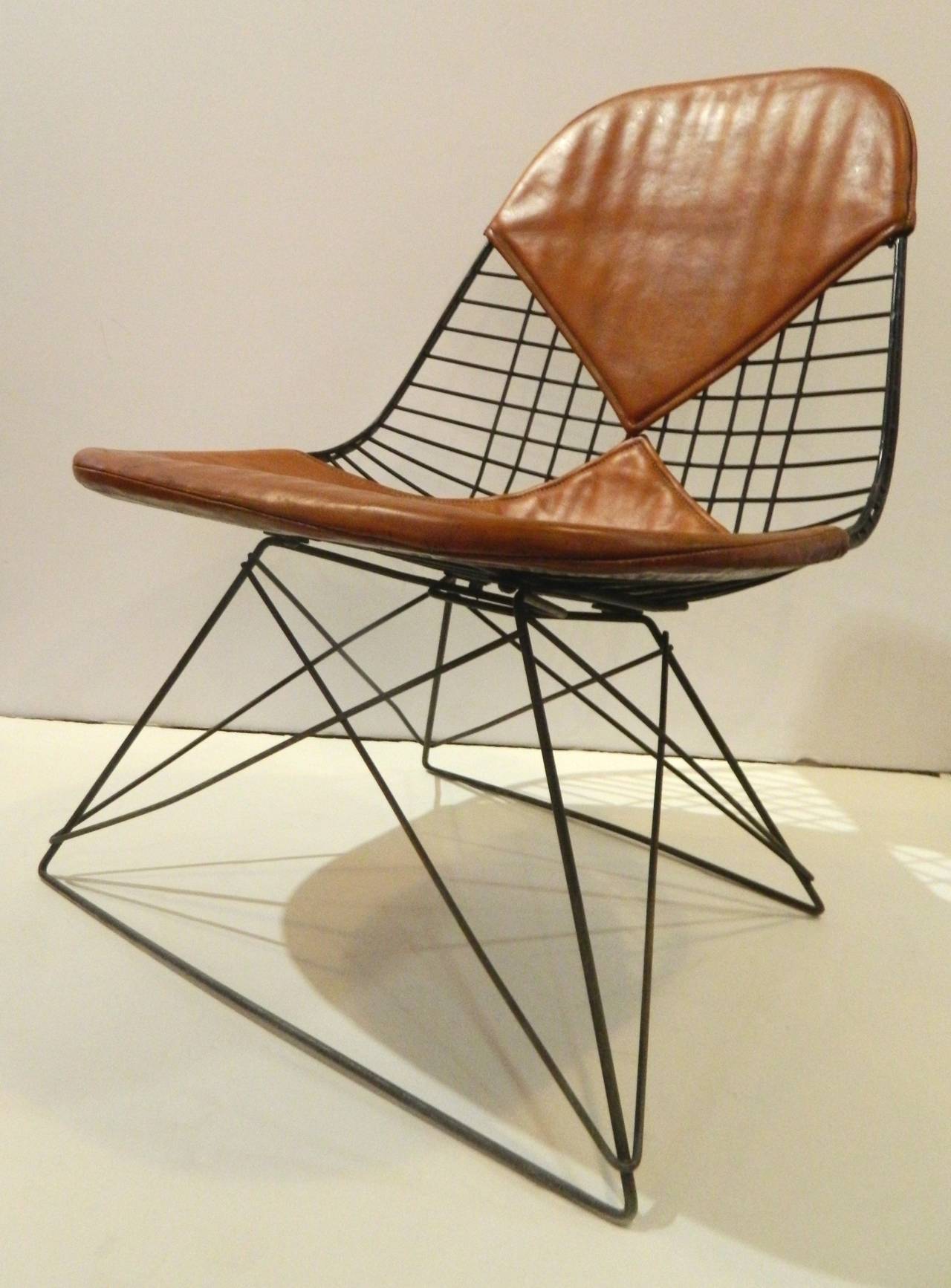 Eames LKR-2 wire chair with cat's cradle base and original upholstery. The jute backing on the seat pad dates the chair from between 1951 and 1957.
Two piece seat with original label. One 1
