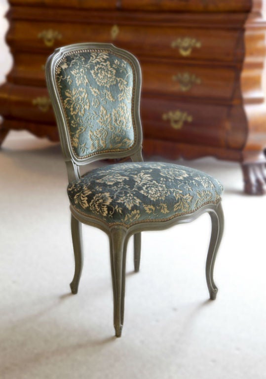 Set of 8 Louis XV style chairs made by Jansen in the 1940's. The wood frames have green paint. The vintage green upholstery is still usable.