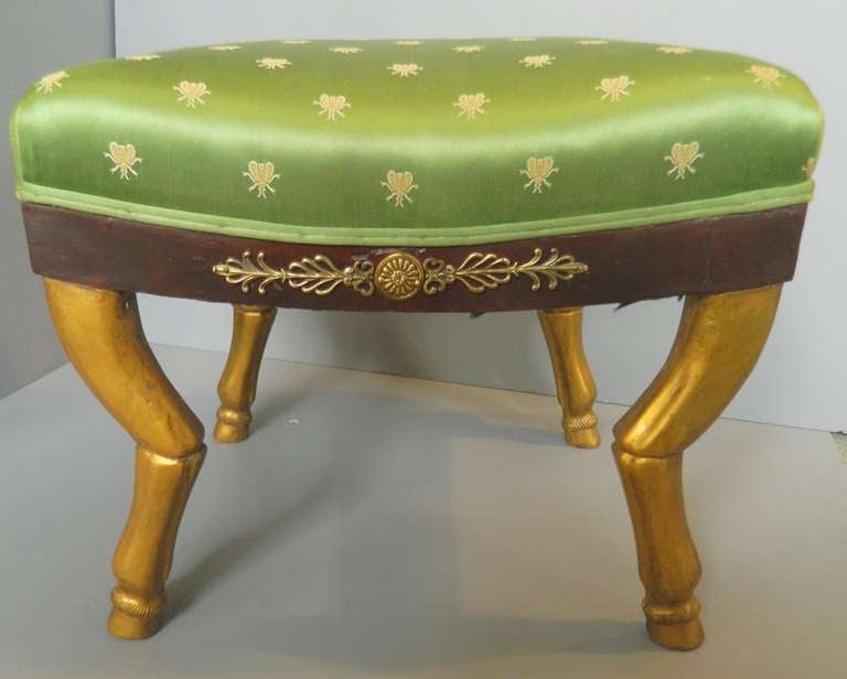 First Empire foot stool with carved gilt wood hooved feet and applied gilt bronze decoration on each of the four sides.