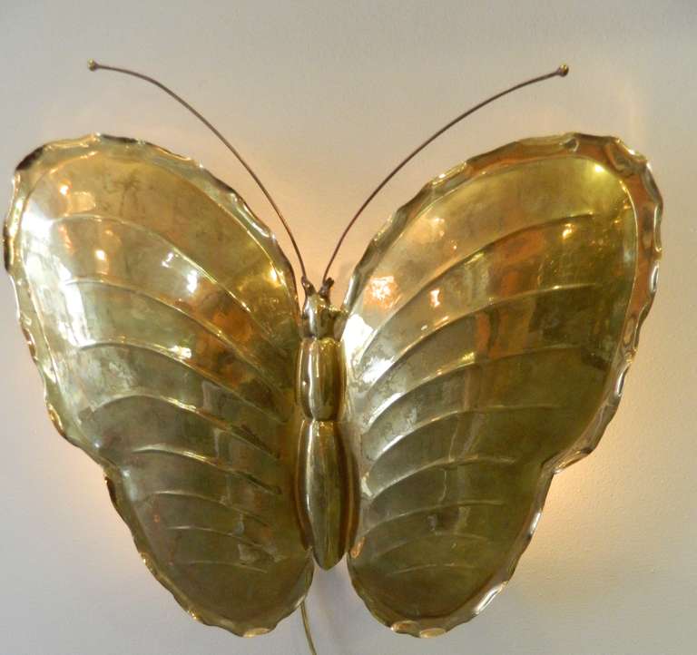 One large two light brass butterfly wall sconce made in Italy in the 1960's. It is stamped on the back RC.