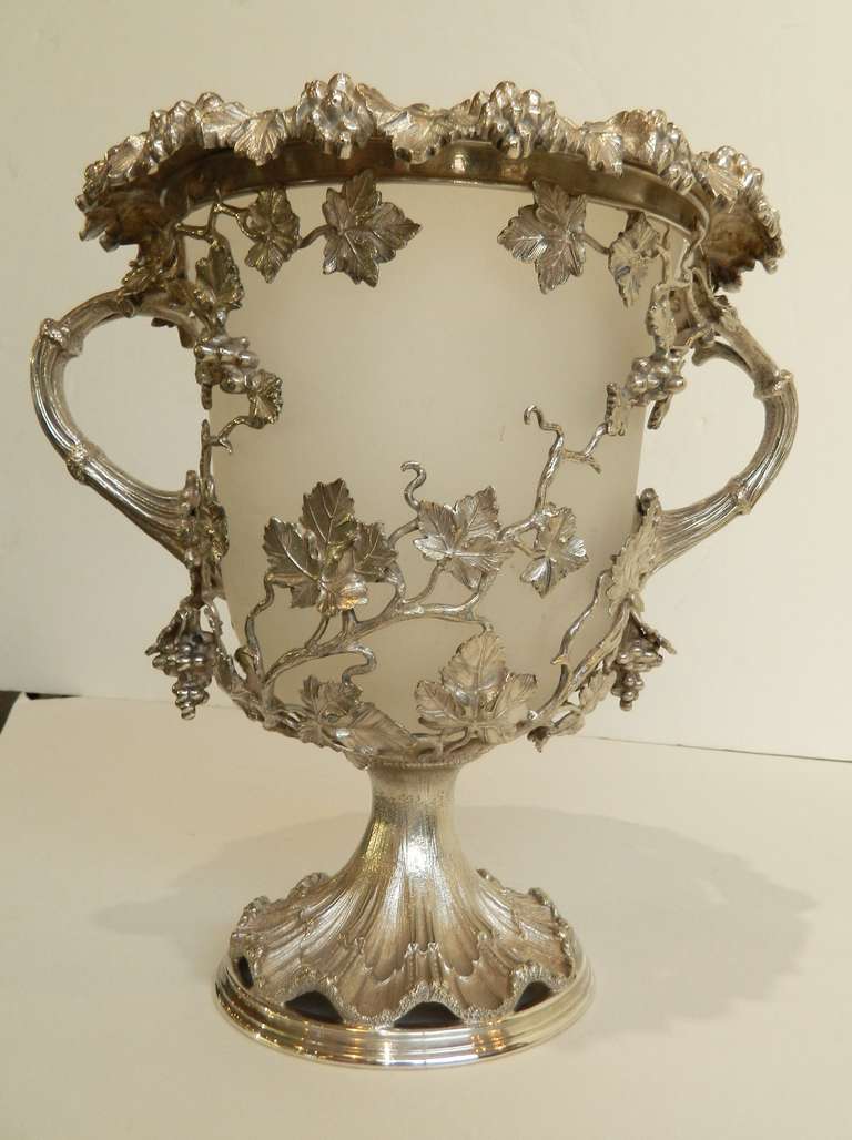 Ornate pair of English silverplate wine coolers with openwork grape vines and clusters forming a frame for a frosted glass liner.  Height is 11