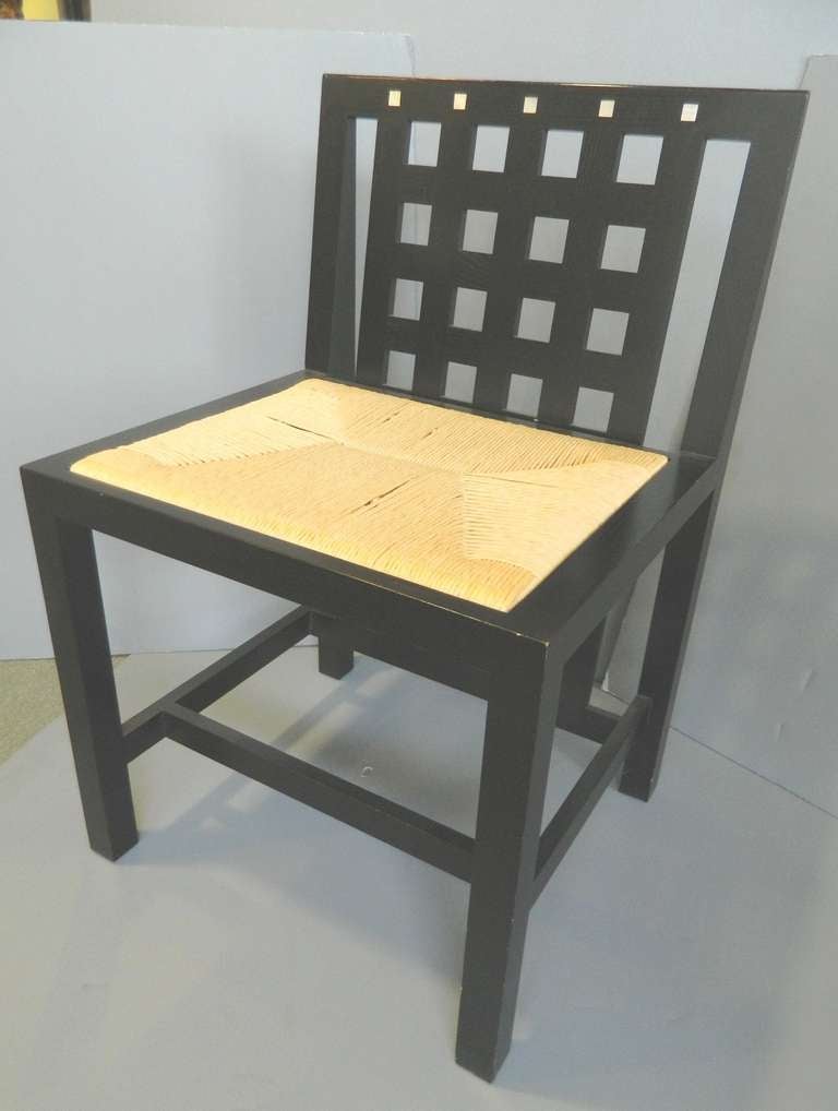 Group of six chairs designed by Charles Rennie Macintosh,  made by Cassina. Ebonized oak with mother of pearl inserts.