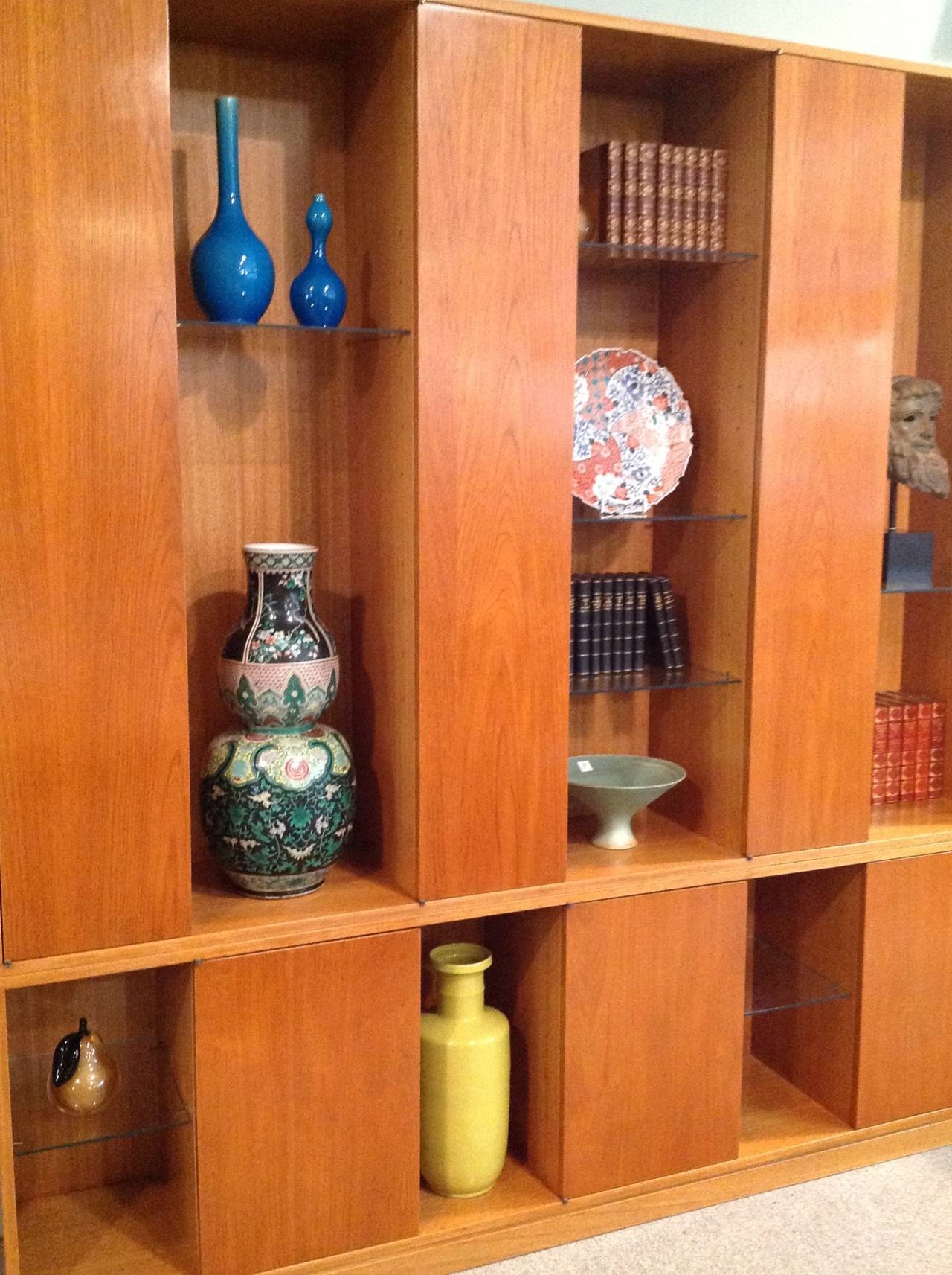 Wall unit designed by Harvey Probber with alternating glass and cabinet sections. Excellent condition with original finish. It has 7 large glass shelves, 3 small glass shelves and 6 wooden interior shelves. Circa 1960's.