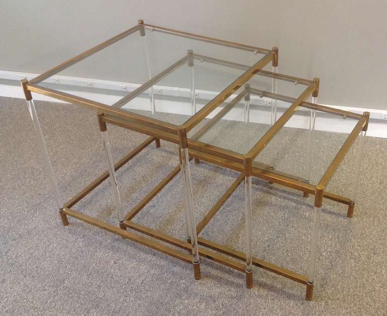 Three Italian Mid-Century Modern brass and lucite nesting tables, metal frames supported by cylindrical lucite supports