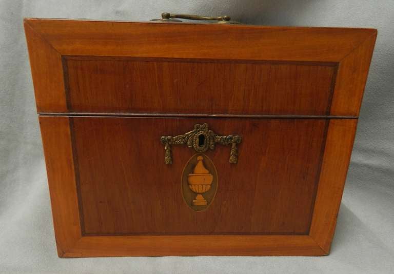 Small scale Dutch mahogany liqueur decanter box with satinwood banding, urn inlay containing 6 decanters and a pair early liqueur glasses that are glue repaired and with the original lock and key made in the early 19th century. There is an extra