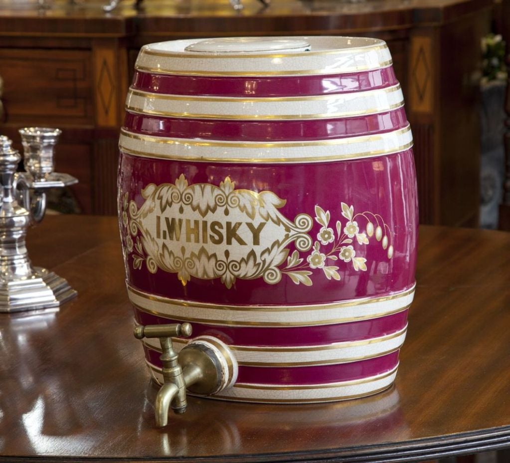 Maroon, white and gold pottery antique Irish whisky barrel from England with a brass spout. There is another very similiar with slightly different decoration also available.