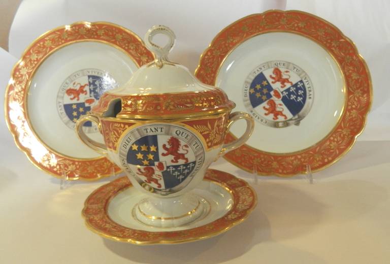 Antique English sauce tureen and two plates made by Flight and Barr Worcester Armorial Porcelain Collection circa 1801-1804. The charming small sauce tureen has a twist finial with a lion quartered coat of arms and motto on the front and back of the