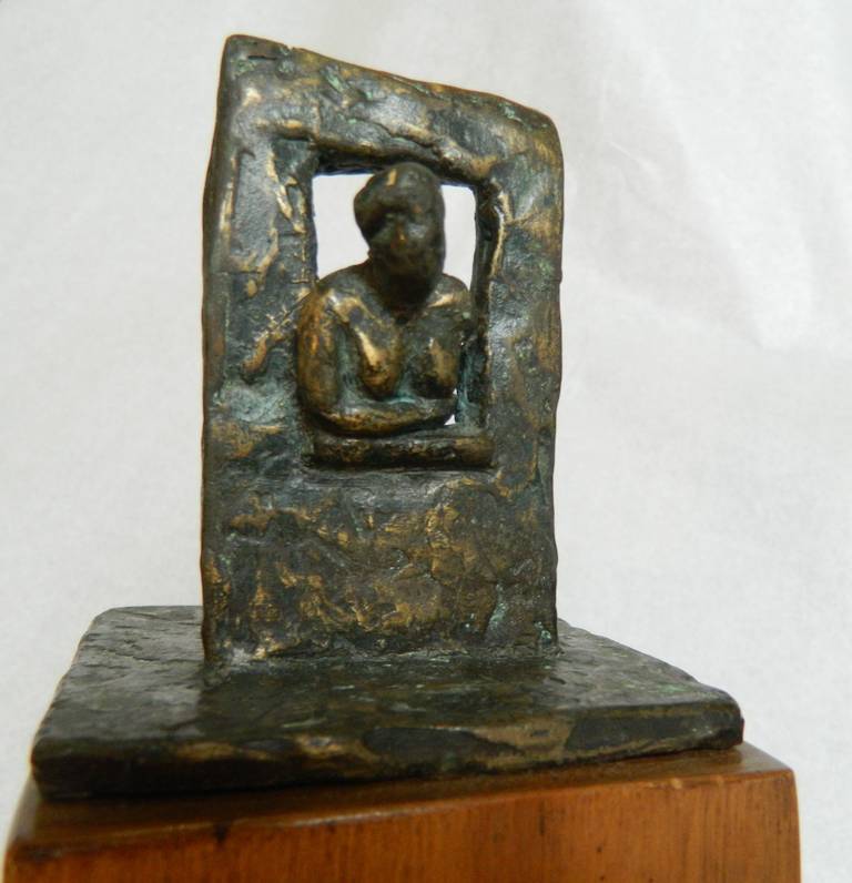 Bronze figure of a nude woman leaning out a window by Houston artist Marie P. Lesher on a wood base. She exhibited in the Northeast in the 60's.