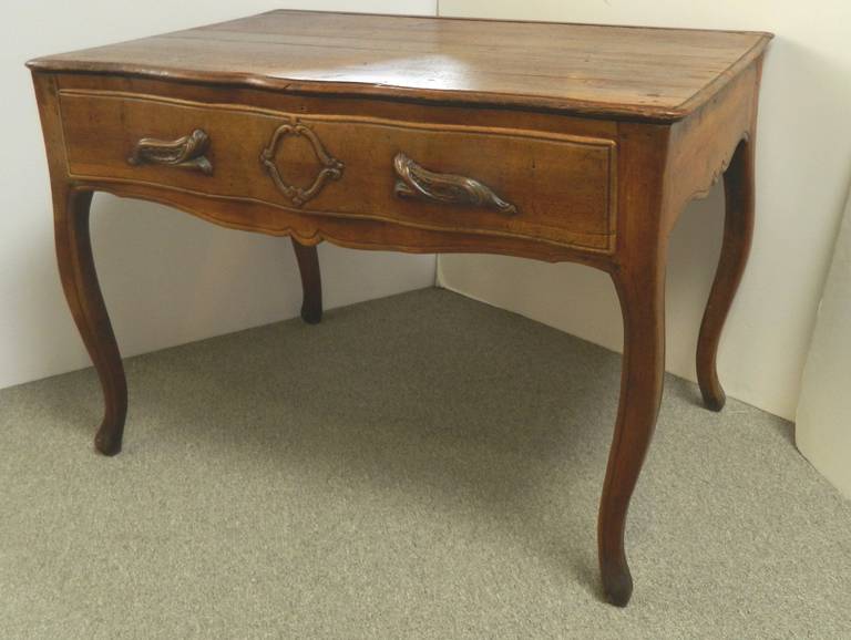 Country French walnut dressing table with one long drawer- perfect for a small desk. Notice the shaped front and cabriole legs. This handmade piece is unusual- the drawer shows below the curve on both sides and back as in pictures 8 and 9. There is