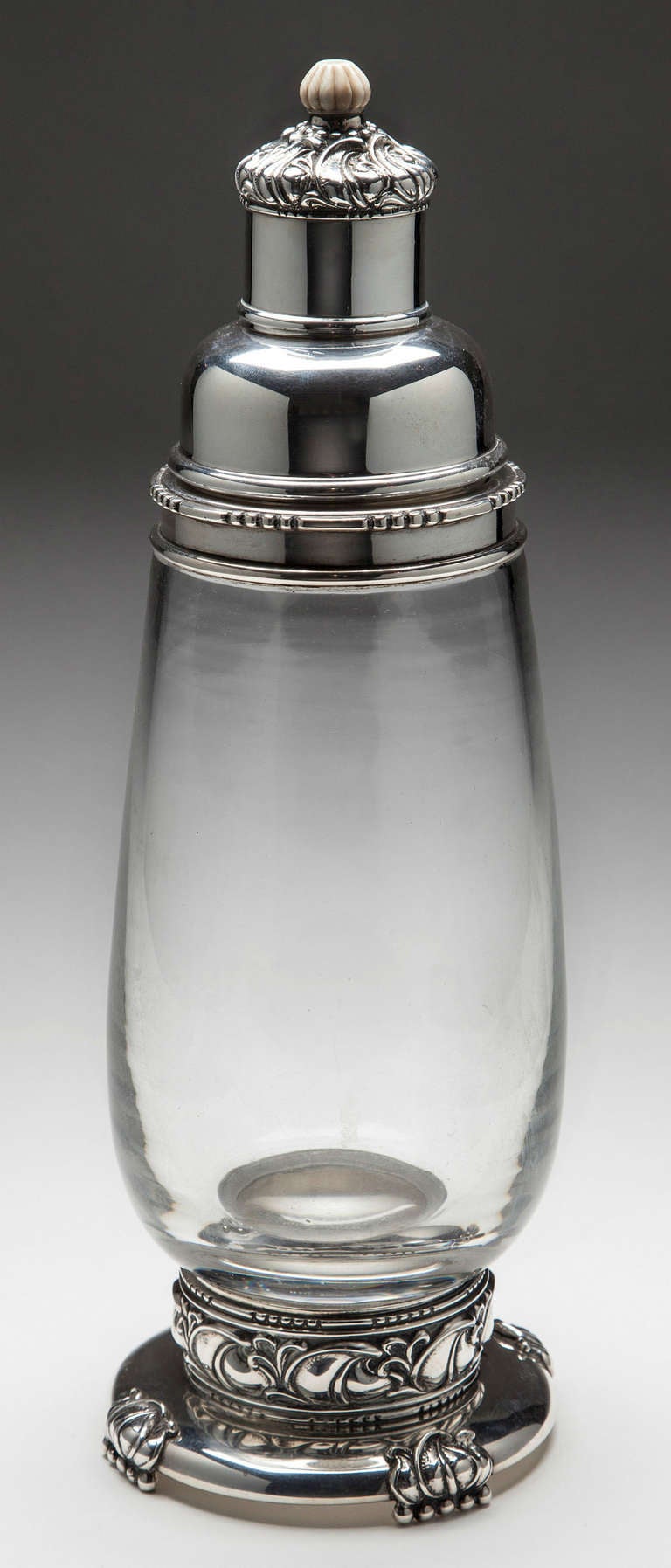 Large Art Deco style sterling and glass cocktail shaker made by Quaker Silver Company, Attleboro Massachusetts, 1926-59 when it was bought by Gorham. This large shaker is 13.5 inches high.
