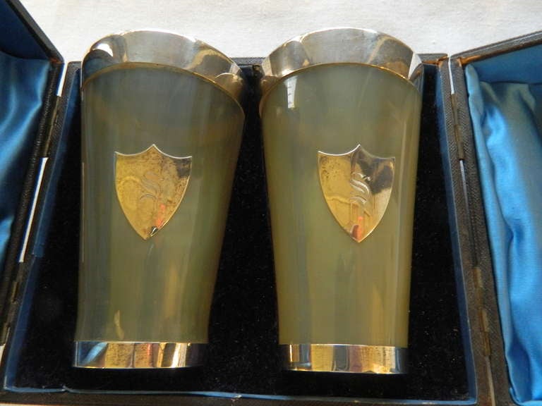 Pair of late 19th century translucent horn beakers made by Aitchison, Edinburgh with silver mounts in a satin presentation case. The bases are stamped Aitchison. It is monogrammed S on a shield shape silver medallion. Excellent condition with minor