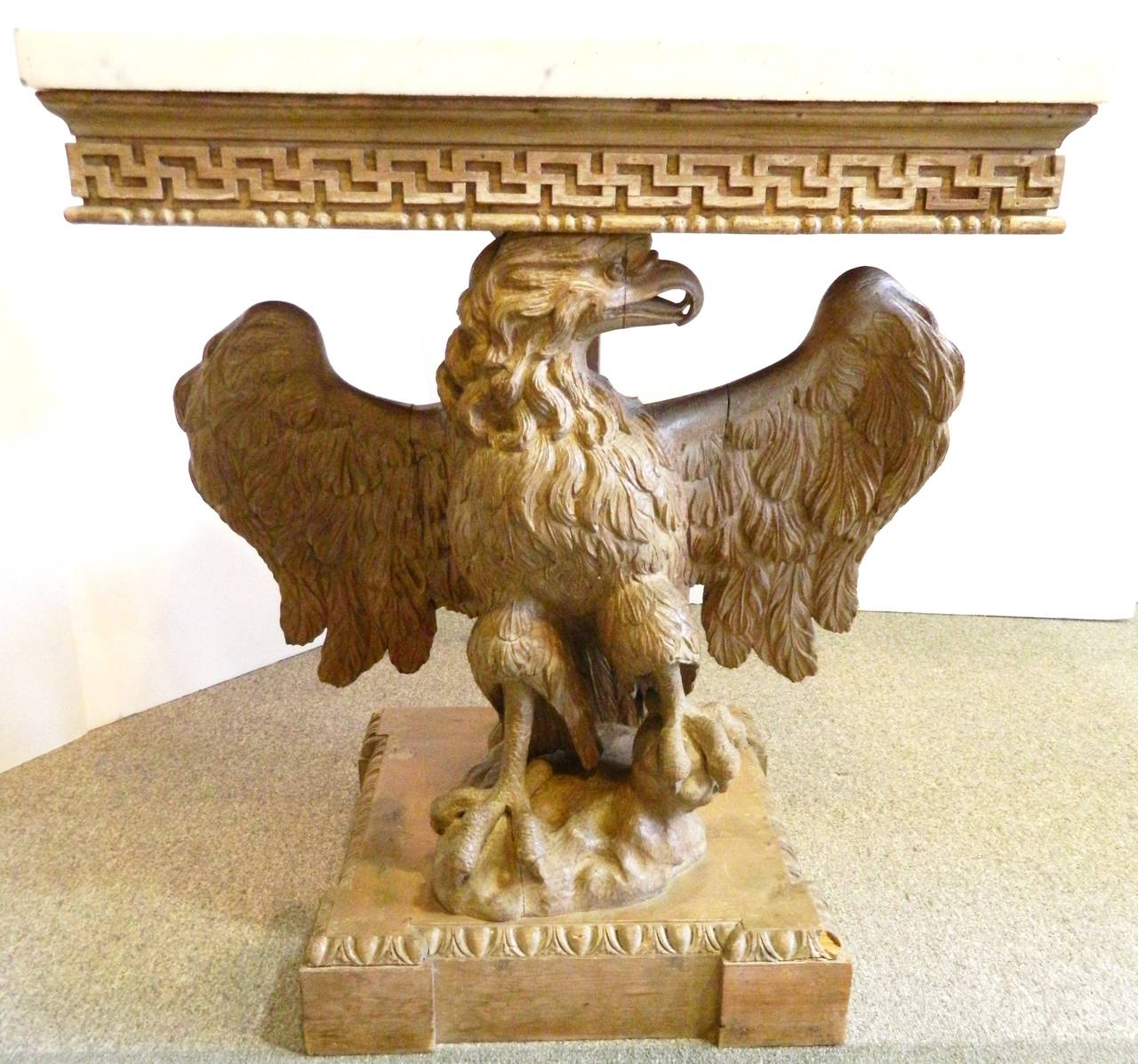 A pair of antique English carved wood eagle consoles with lapis lazuli and marble tops, circa 19th century.