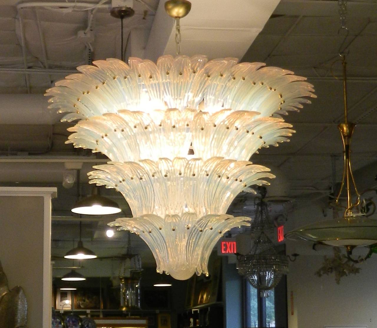 Large opaline glass chandelier attributed to Barovier and Toso titled palmette. Made in Italy, 1960s. There are four-tiers of layered opaline glass palm leaves and a textured ball base. It is four-light with a white metal frame.