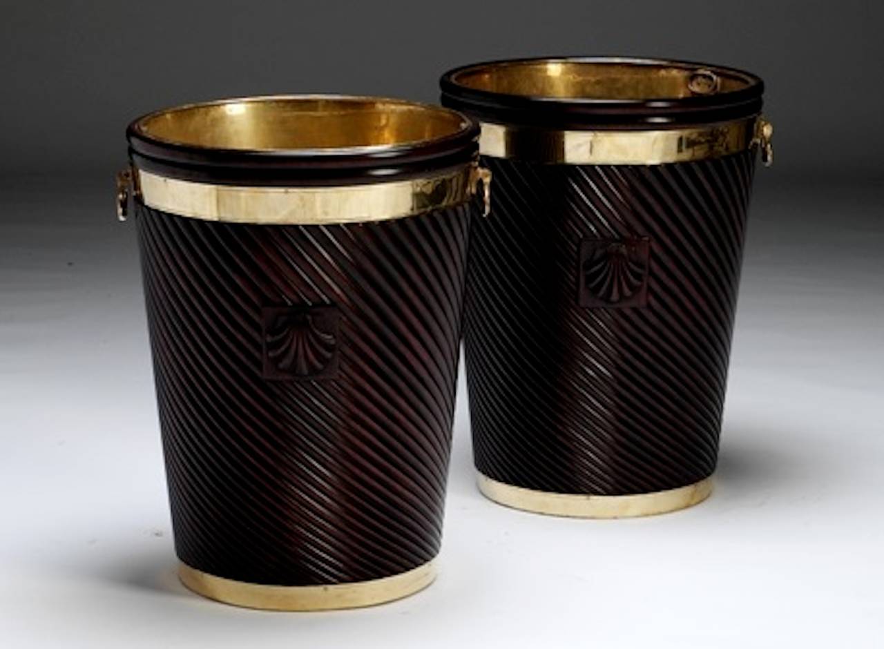 A pair of handsome brass bound mahogany Irish Georgian style turf buckets that would be ideal for logs. The fitted brass liner would also make it suitable for plants and flowers or for umbrellas and sticks. The distinctive carved shell on the