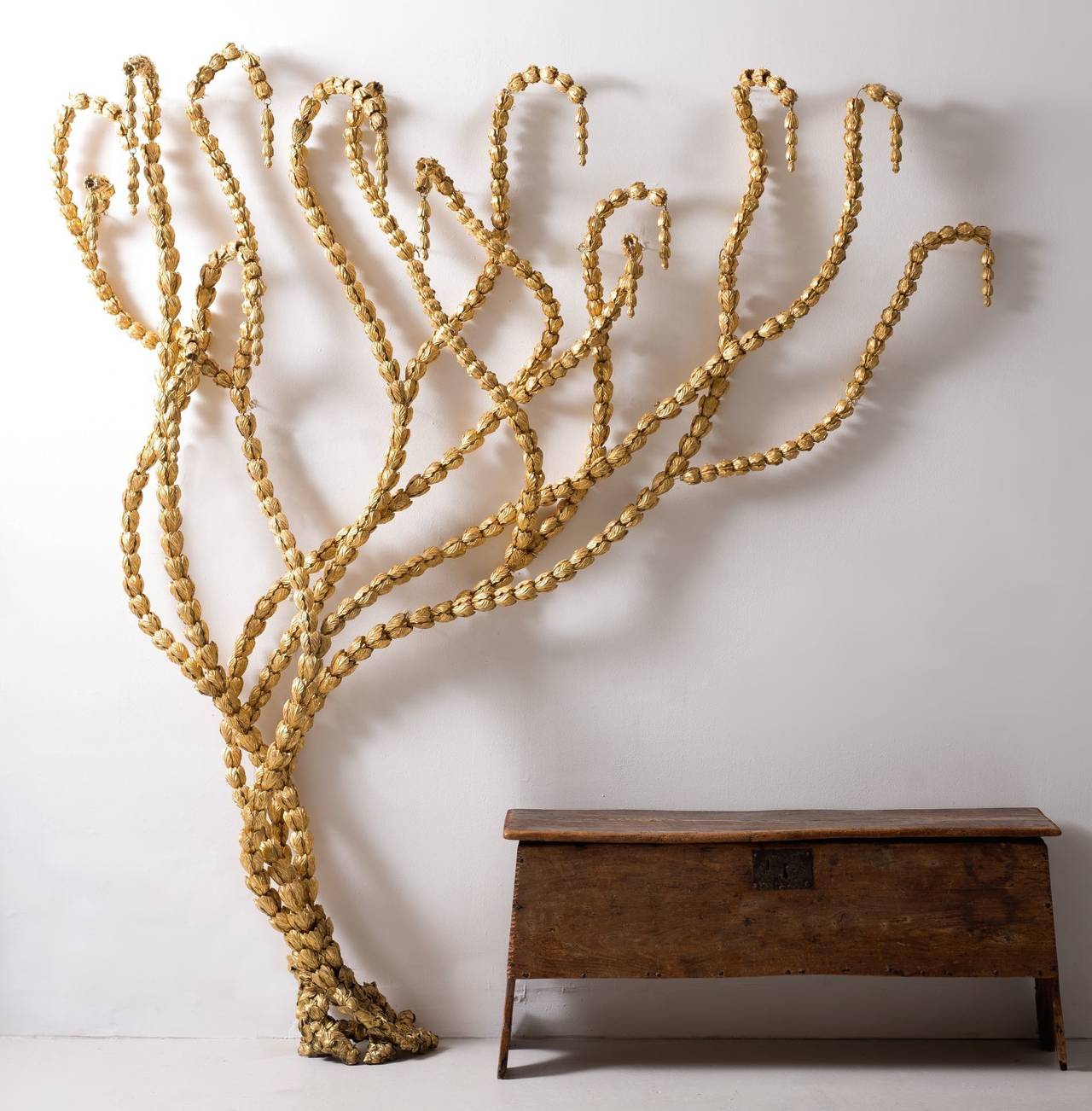Resin, 23-carat gold leaf and brass.

Adams Vine is made up of 1000 cast and gilded husks strung on brass wire and trained up an interior wall in Classical Rococo style. The composition is versatile. It can be trained up a vertical interior wall,