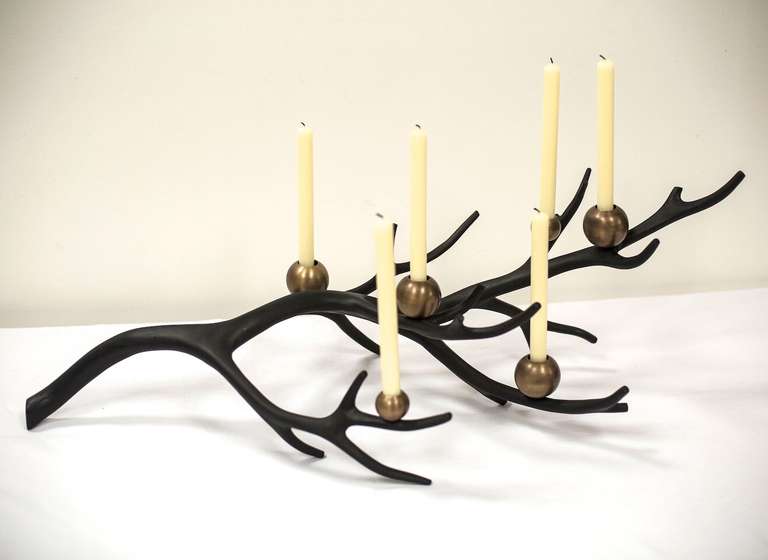 This six candleholder centrepiece is by the versatile designer maker Tom Palmer whose skilled hand has taken the traditional heavy 'baronial' style  familiar in using antlers for interiors and applied a technique that results in a 21st century