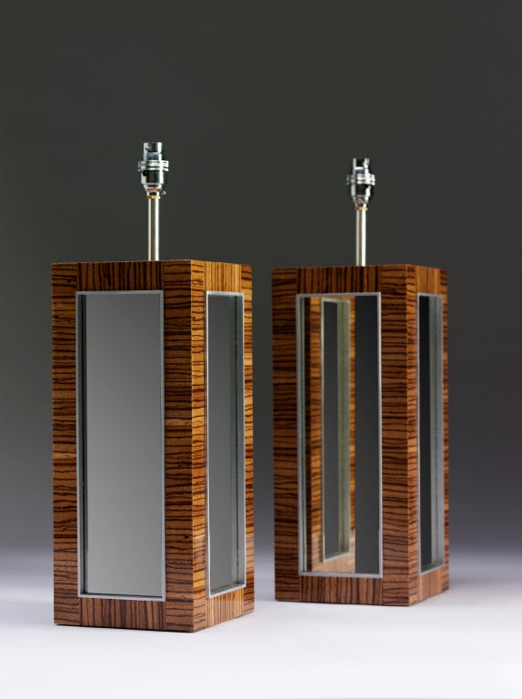 A pair of Zebrano veneered modernist lamps with recessed distressed mirror glass and silvered beading.

The lamps shown here are sold as shown, but can be ordered in shagreen and alternative finishes.
ELG at Sainsburys is under the direction of
