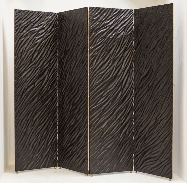 This four panel screen is created with a unique process combining intensive hand carving with erosion and shaping by flame of the high-grade birch laminate panels. These are then repeatedly waxed and polished to build up a deep, rich patina. 

The